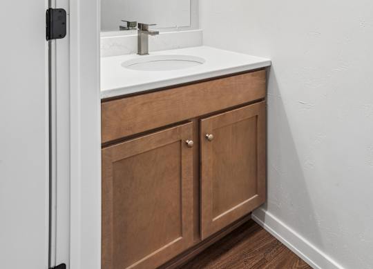 A bathroom with a sink and a mirror.