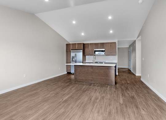 A kitchen with wooden floors and a countertop.
