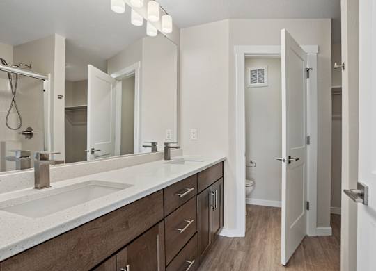 A bathroom with a sink, mirror, and wooden cabinets.