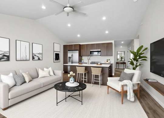 A living room with a white couch, a black coffee table, and a ceiling fan.