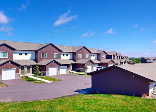 A large, modern house with a driveway and garage.