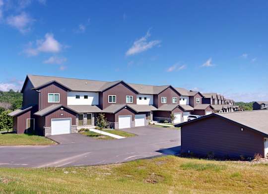 A row of houses with a clear blue sky above them.
