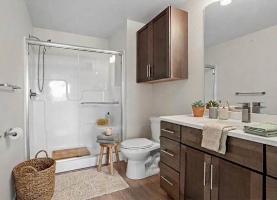A bathroom with a toilet, sink, and shower.