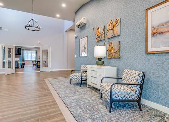 A living room with a blue wall and a chair.