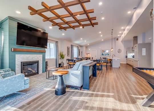 A modern living room with a fireplace and a TV mounted above it.