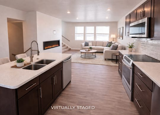 A modern kitchen with dark wood cabinets and a white countertop.