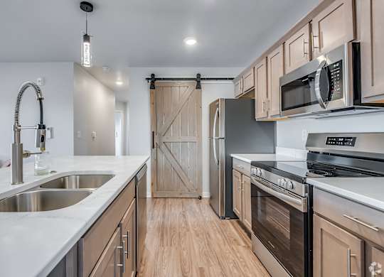 A kitchen with wooden cabinets and stainless steel appliances.