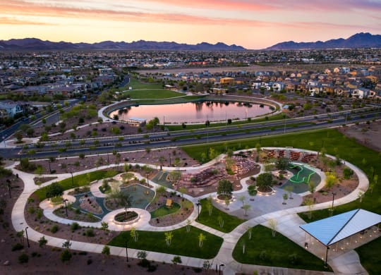 an aerial view of the skate park at sunset with the city in the background