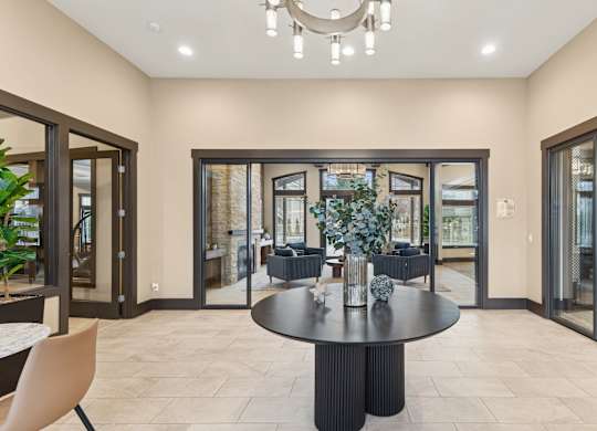 A modern dining room with a round table and chairs.