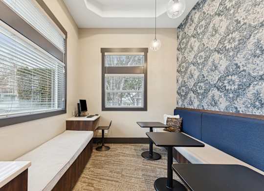 A room with a window, a desk, and a bench.