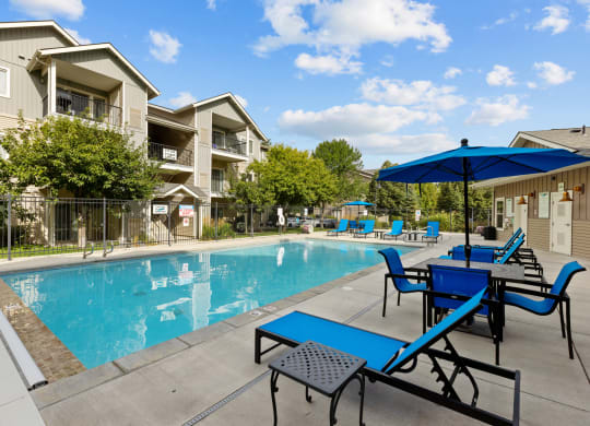 our apartments have a pool and patio with chairs and umbrellas