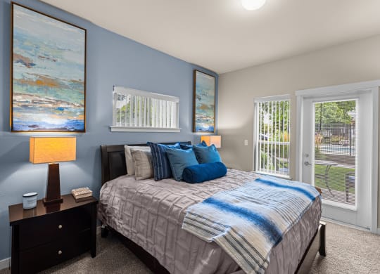 a bedroom with a bed and two windows