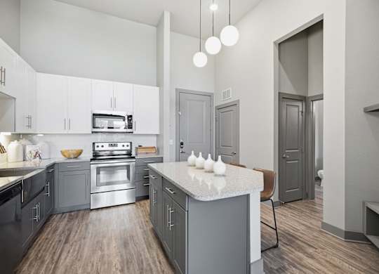 A modern kitchen with a stove top oven and a microwave.