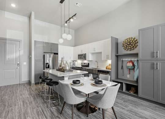 A modern kitchen with a dining table and chairs.