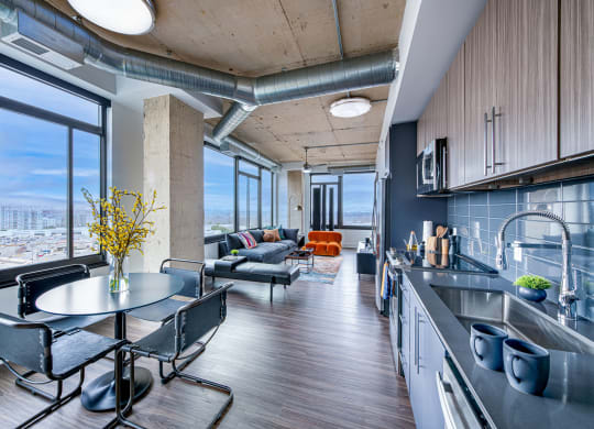 a kitchen and living room in an apartment with a large window