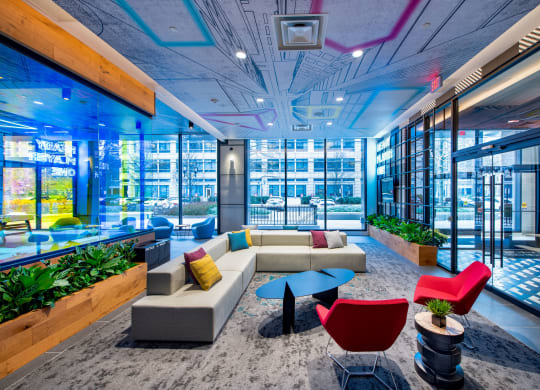 a lounge area with couches and chairs in a lobby of a building