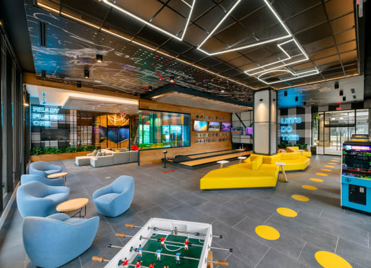 a lounge area with couches and chairs and a pool table