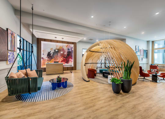 the lobby of a hotel with a large pod in the center