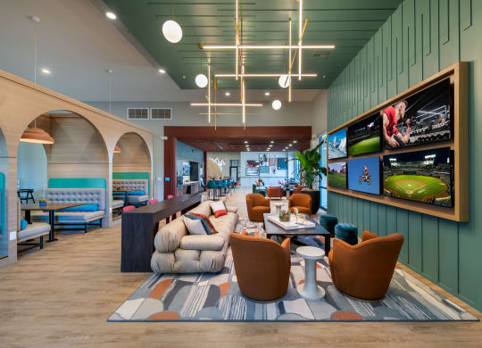 the lobby of a hotel with couches and tables and chairs