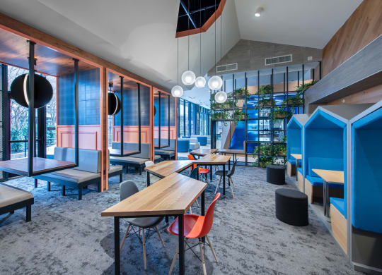 a restaurant with tables and chairs in a room with glass walls