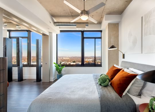 a bedroom with a large bed and a ceiling fan