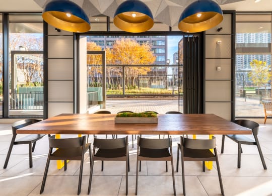 a dining room with a table and chairs in front of a window