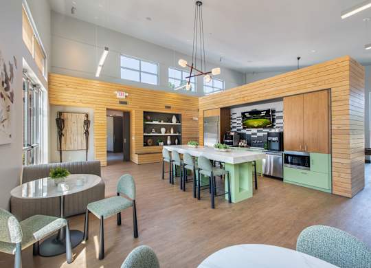 A modern kitchen with a dining table and chairs.