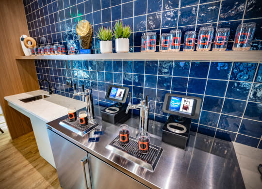 a kitchen with a counter with coffee machines and a tv