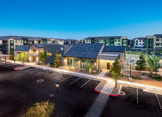 a building with a parking lot and a street in front of it