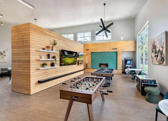 A room with a wooden table and chairs, a television, and a fireplace.