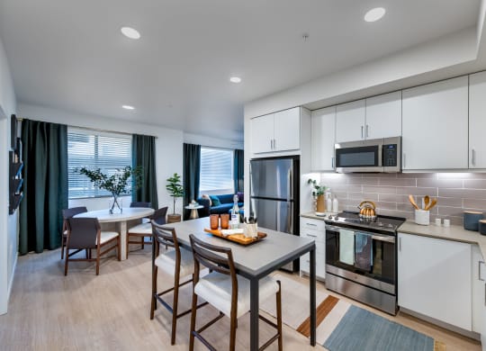a kitchen and dining room with a table and chairs