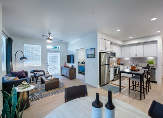 an open living room and kitchen with a table and chairs