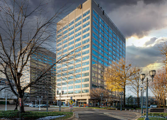 a tall building with a cloudy sky in the background