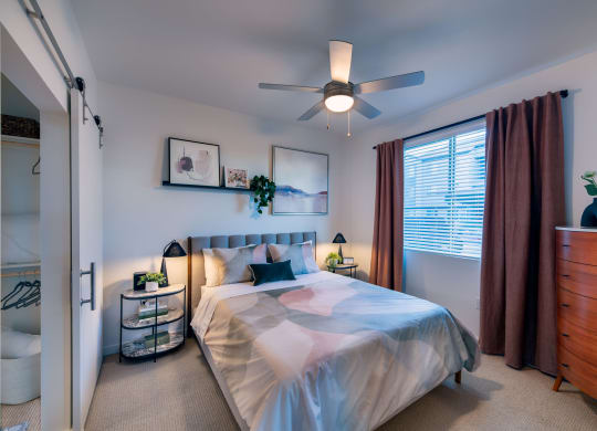 a bedroom with a bed and a ceiling fan