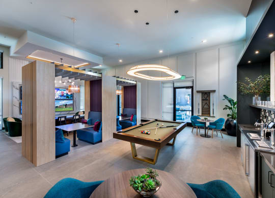 a lounge area with a pool table and a bar