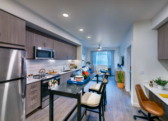 private kitchen with island and stainless steel appliances at the reserve at walnut creek apartments