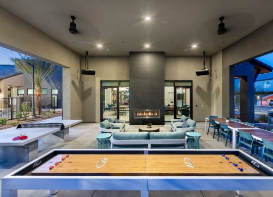 a clubhouse with a pool table and chairs and a fireplace