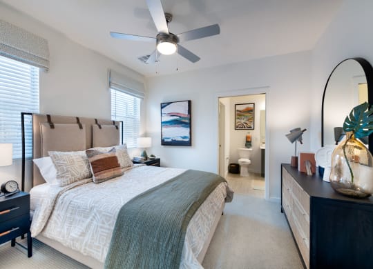 a bedroom with a large bed and a ceiling fan