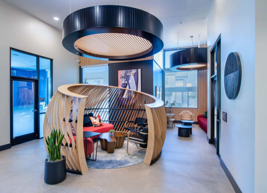 a living room with a wooden spiral staircase and a table and chairs