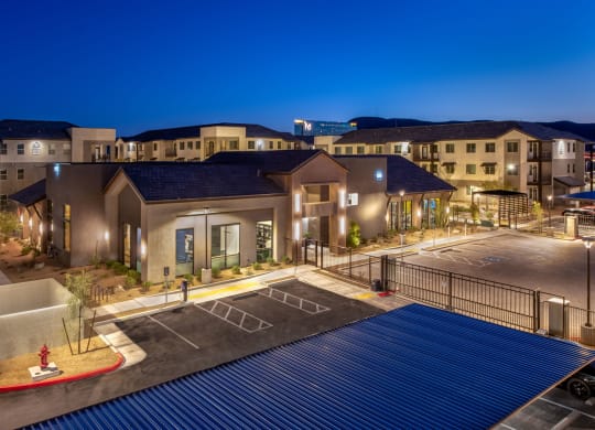 a building with a parking lot at night