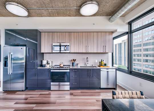 A modern kitchen with wooden cabinets and stainless steel appliances.