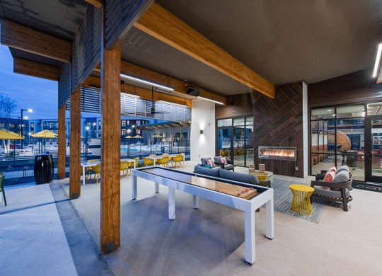 Corsair Apartments Patio Area with Game Table and Fireplace