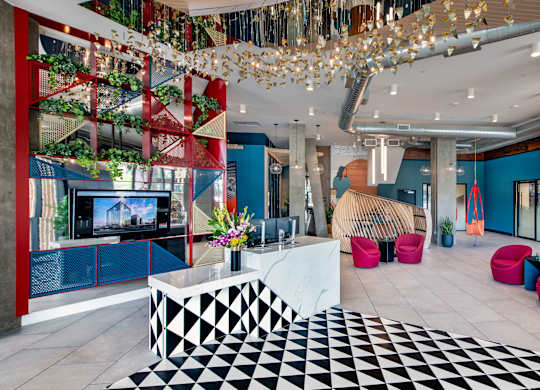 A modern lobby with a black and white checkered floor.