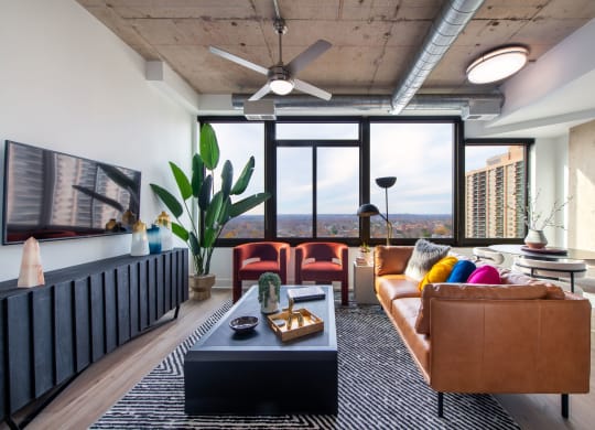 a living room with leather furniture and a large window