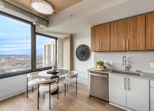 a kitchen with a large window and a table with chairs