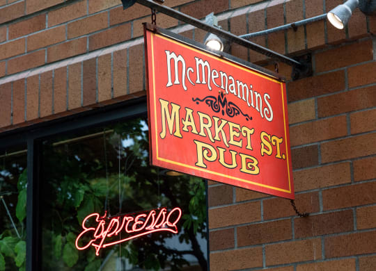 a red sign on the side of a brick building