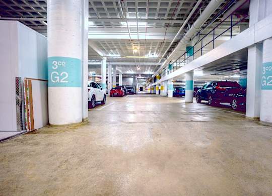 A parking garage with a 300 G2 sign on the pillars.