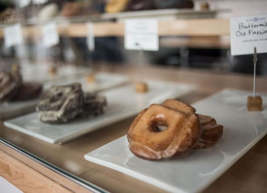a display case filled with different types of donuts and other desserts