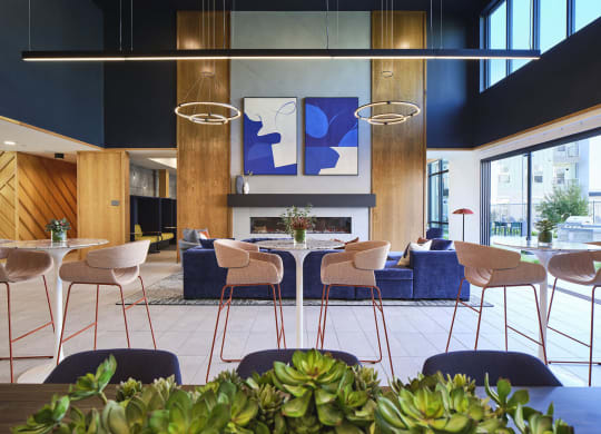 the lobby of a hotel with tables and chairs