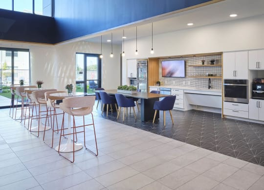 a kitchen with a bar and chairs and a table